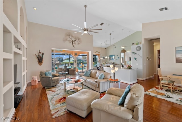 living room featuring dark hardwood / wood-style flooring, ceiling fan, built in features, and high vaulted ceiling