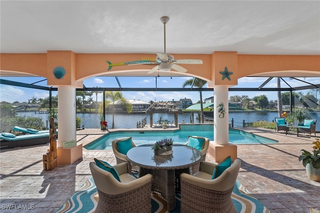 view of pool featuring ceiling fan and a water view