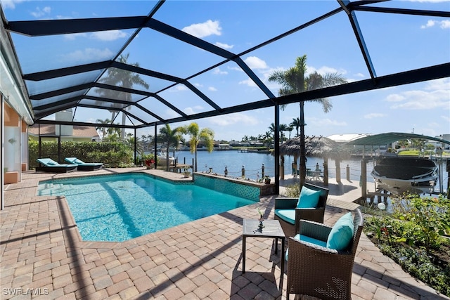 view of pool with a lanai, a patio area, a water view, and a boat dock