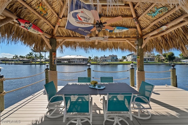 view of dock with a gazebo and a water view