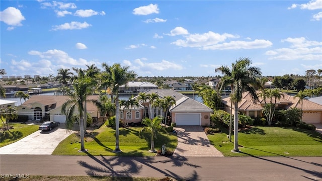 view of front of property featuring a garage and a front lawn