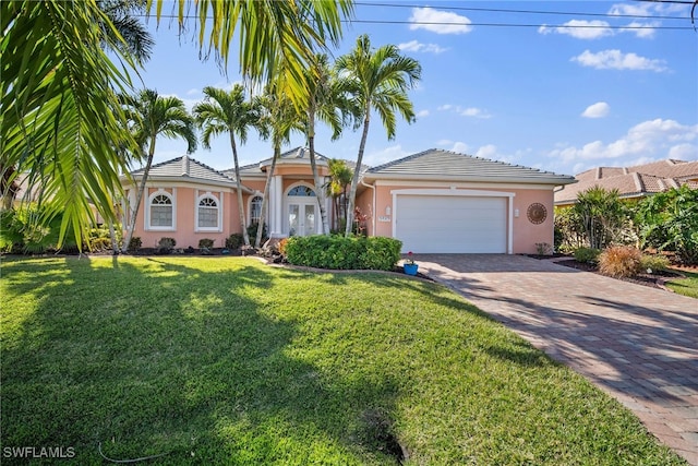 single story home featuring a garage and a front lawn