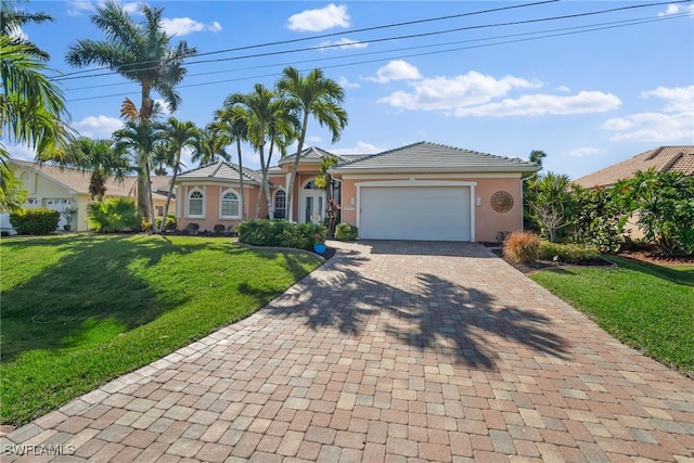 single story home with a garage and a front lawn