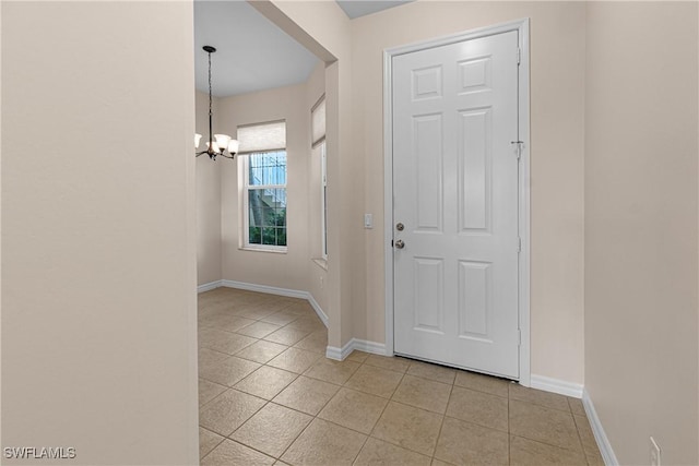 entryway featuring light tile patterned floors and a chandelier