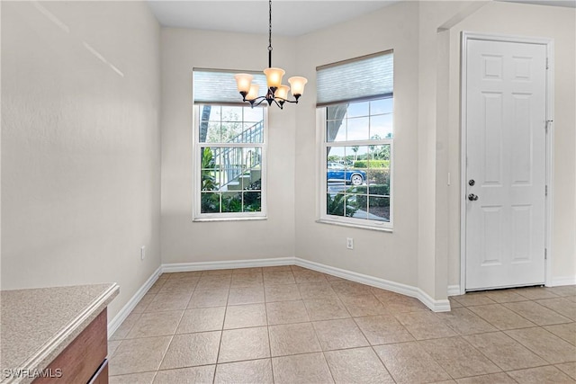 unfurnished dining area featuring light tile patterned floors and an inviting chandelier