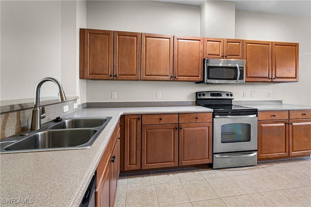 kitchen featuring sink, light tile patterned floors, and appliances with stainless steel finishes