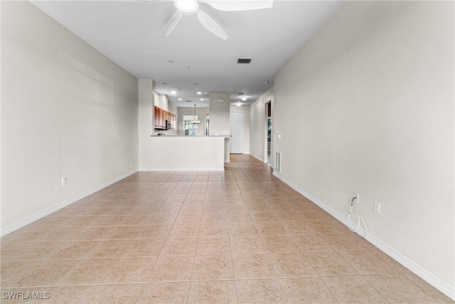 unfurnished living room with light tile patterned floors and ceiling fan