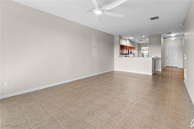 unfurnished living room featuring ceiling fan and light tile patterned flooring