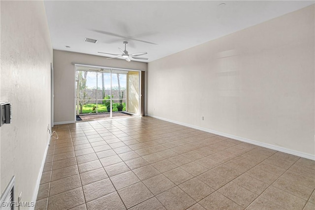 tiled empty room with ceiling fan