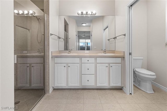 bathroom with tile patterned floors, an enclosed shower, vanity, ceiling fan, and toilet