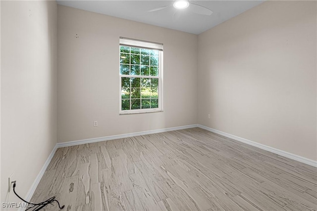 unfurnished room featuring light hardwood / wood-style flooring and ceiling fan