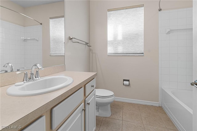 full bathroom featuring tiled shower / bath, tile patterned flooring, vanity, and toilet