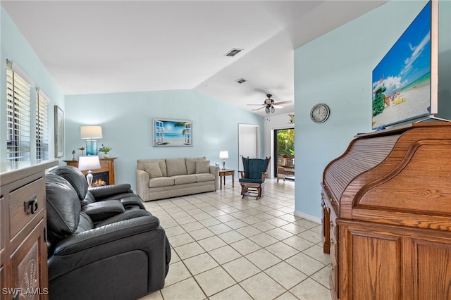 living room featuring ceiling fan, light tile patterned floors, and lofted ceiling