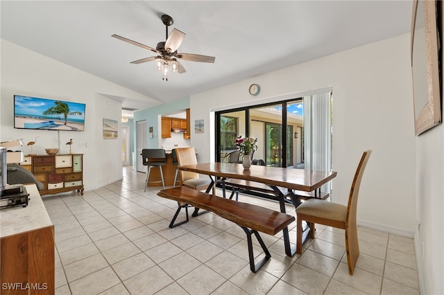 tiled dining area with vaulted ceiling and ceiling fan