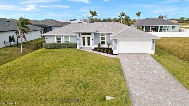 view of front of property featuring a front lawn, a garage, and french doors