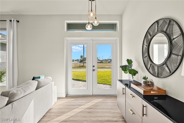 entryway with french doors and light hardwood / wood-style floors