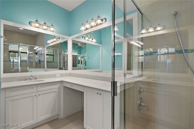 bathroom with tile patterned flooring, vanity, and a shower with door