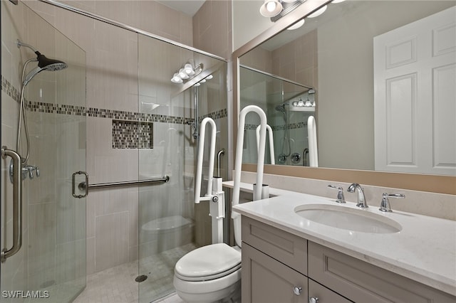 bathroom featuring vanity, an enclosed shower, and toilet