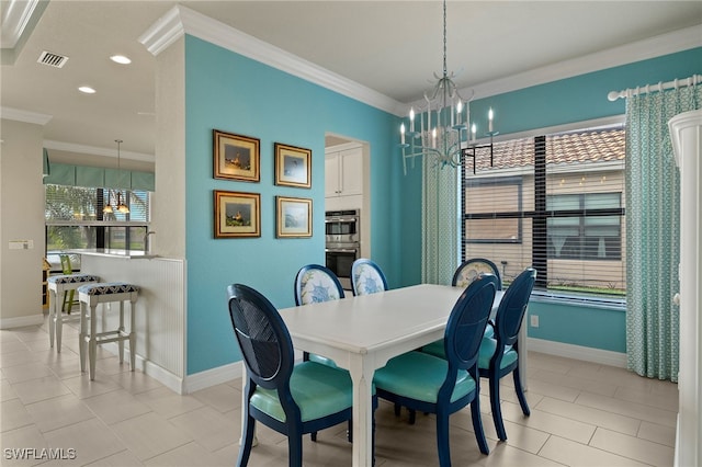 tiled dining room featuring plenty of natural light, crown molding, and an inviting chandelier