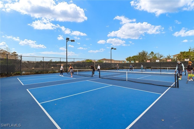 view of tennis court featuring basketball court