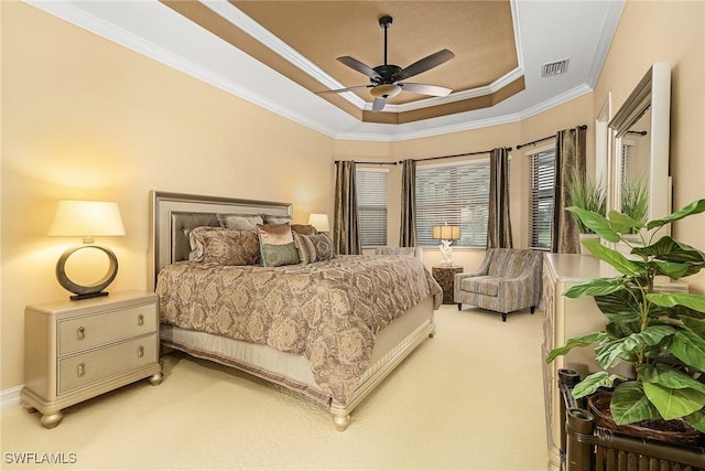 carpeted bedroom featuring a raised ceiling, ceiling fan, and crown molding