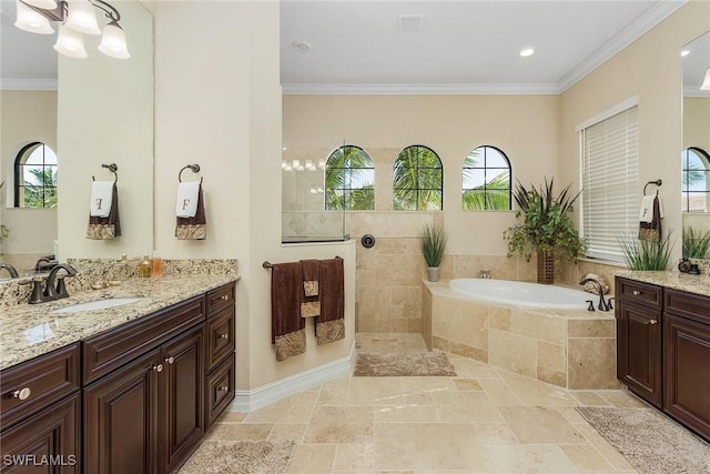 bathroom featuring vanity, a relaxing tiled tub, and ornamental molding