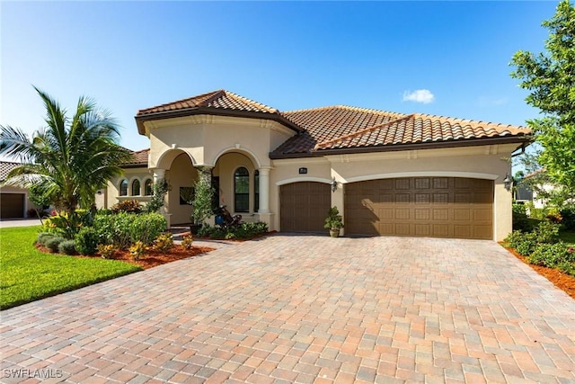 mediterranean / spanish house with a garage