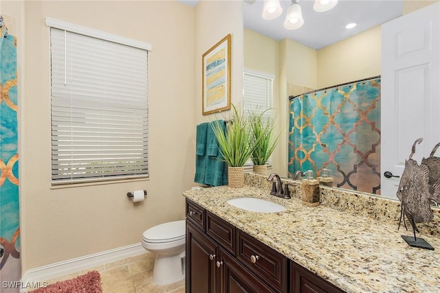 bathroom featuring vanity, curtained shower, and toilet