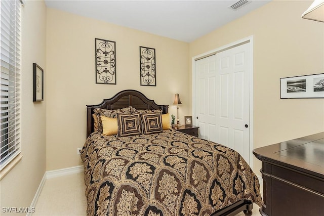 bedroom featuring light colored carpet and a closet