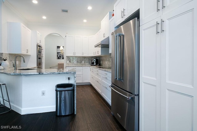 kitchen featuring light stone countertops, sink, white cabinetry, and stainless steel appliances