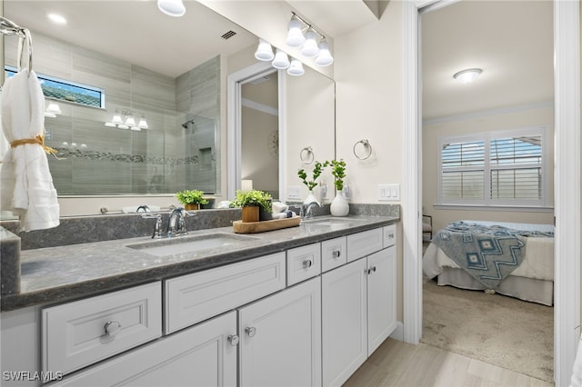 bathroom featuring vanity, an enclosed shower, and ornamental molding