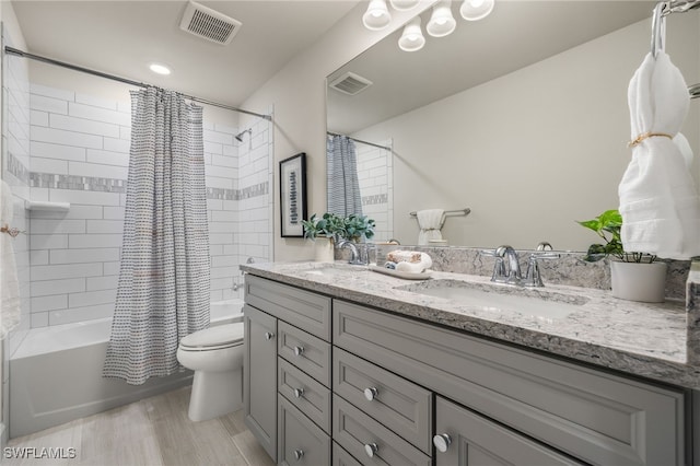 full bathroom featuring vanity, toilet, and shower / tub combo with curtain