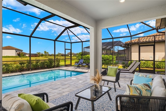 view of swimming pool featuring an outdoor hangout area, glass enclosure, and a patio area