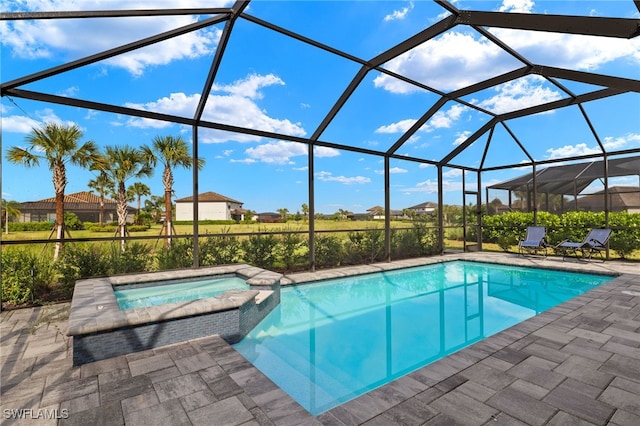 view of pool featuring a patio area, a lanai, and an in ground hot tub