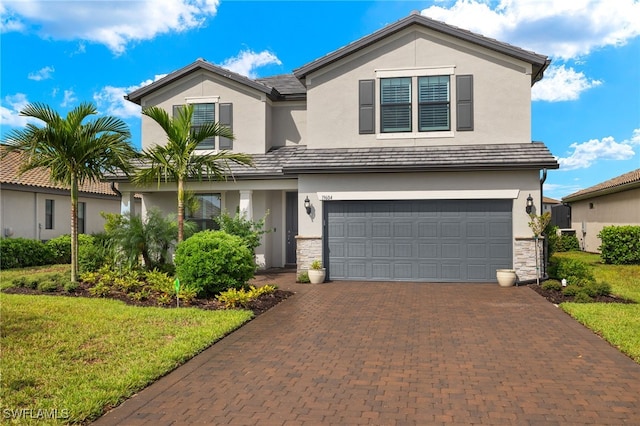 front facade featuring a front yard and a garage