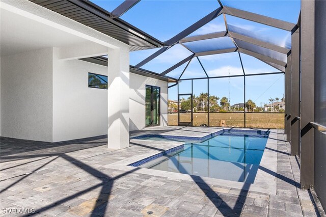 outdoor pool with a lanai, a patio, and a hot tub