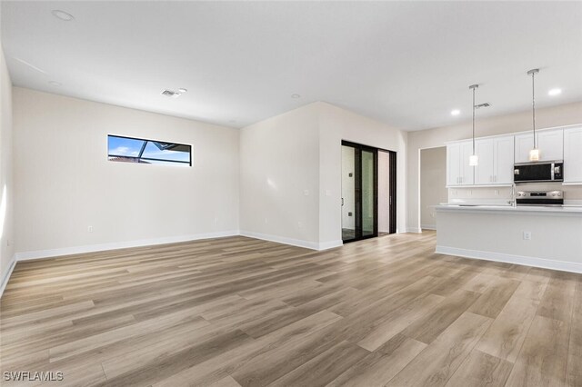 unfurnished living room featuring light wood-type flooring