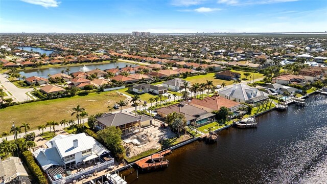 drone / aerial view with a water view and a residential view