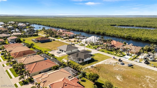 drone / aerial view featuring a residential view and a water view