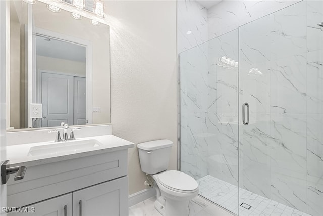 full bathroom with a marble finish shower, baseboards, toilet, marble finish floor, and vanity