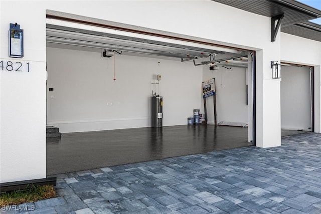 garage featuring a garage door opener and water heater