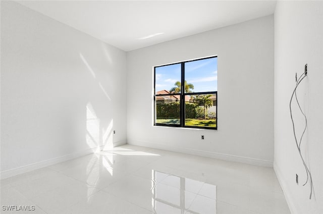 unfurnished room featuring light tile patterned floors