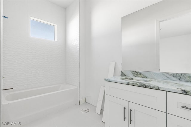 bathroom featuring tile patterned floors, vanity, and tiled shower / bath