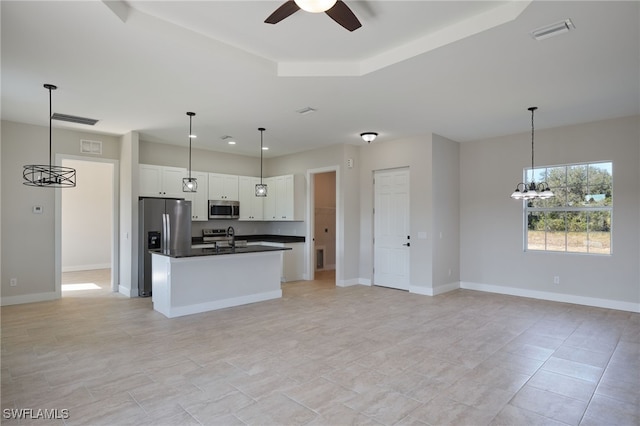 kitchen with a sink, dark countertops, visible vents, and stainless steel appliances