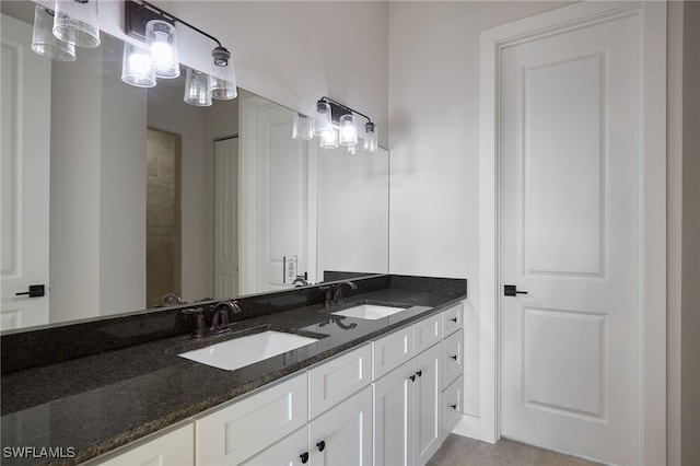 full bathroom with double vanity and a sink