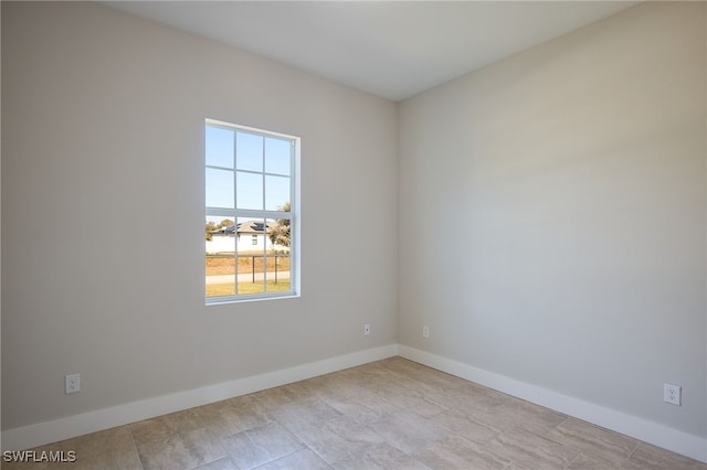 spare room featuring baseboards