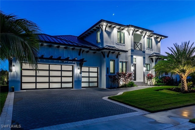 view of front of property with a yard and a garage