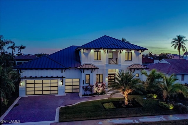 view of front of home with a balcony and a garage