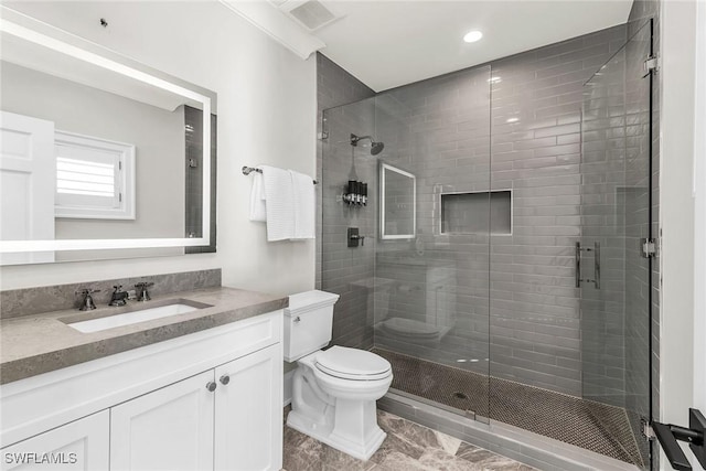 bathroom with vanity, toilet, and walk in shower