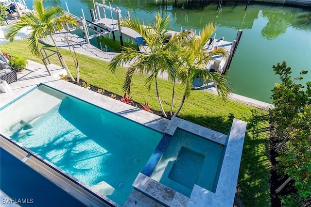 view of swimming pool featuring a lawn, a dock, and a water view